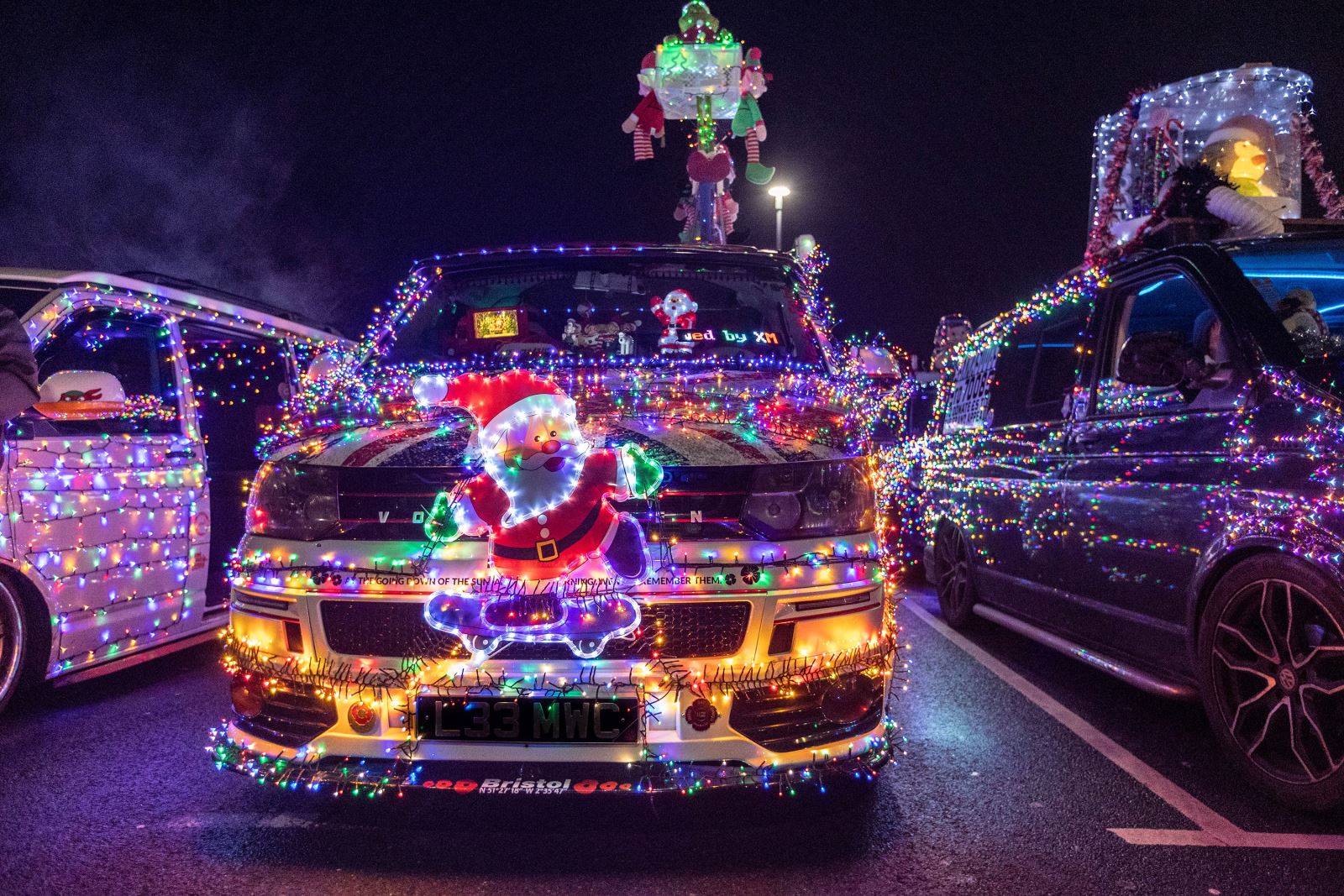 A VW van decorated with Christmas lights and with a Santa on the grille at the annual Vee Dub Cruz in Weston-super-Mare